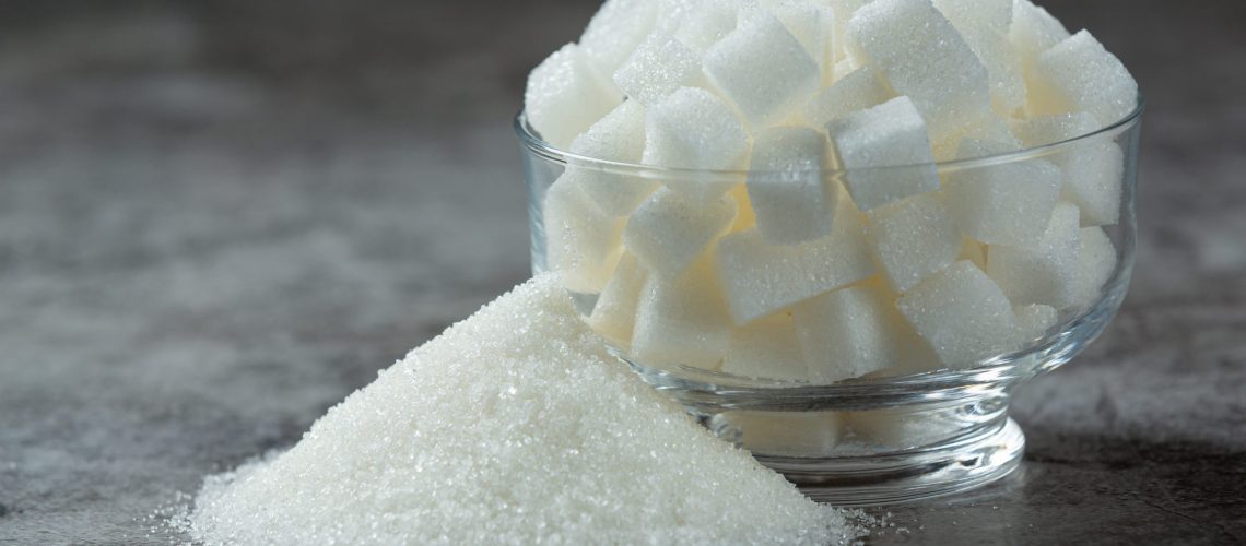World diabetes day;
Sugar cubes in a glass bowl on dark floor